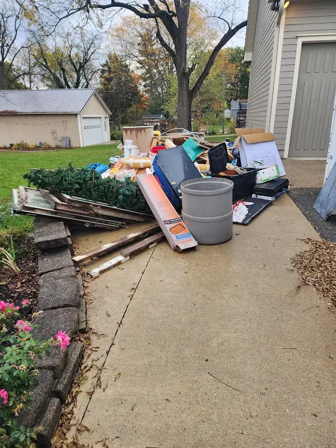 Dumpster being loaded with debris for 12 Yard Dumpster Rental in North Bend